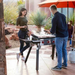 Camp Chef 30-Inch 4-Burner Freestanding / Countertop Propane Gas Commercial Style Flat Top Griddle -BBQDIRECT Shop Camp Chef 30 Inch 4 Burner Tabletop Freestanding Flat Top Griddle FTG600P Lifestyle Cooking Couple