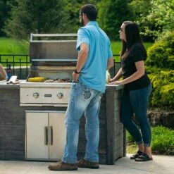 Coyote Ready-To-Assemble 5 Ft. Outdoor Kitchen Island For Natural Gas Grill And Access Door - Gray Weathered Wood -BBQDIRECT Shop Coyote Ready To Assemble 5 Ft Outdoor Kitchen Island Gray Weathered Wood RTAC G5 WG Lifestyle People 1