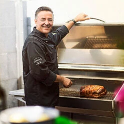 Memphis Grills Pro Wi-Fi Controlled 28-Inch 304 Stainless Steel Freestanding Pellet Grill - ITC3 Model -BBQDIRECT Shop Memphis Grills Pro Wi Fi Controlled 28 Inch 304 Stainless Steel Freestanding Pellet Grill VG0001S Chef Cooking On Grill 2